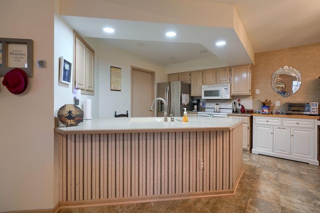 kitchen featuring sink, white appliances, and kitchen peninsula