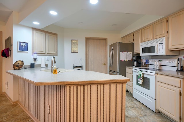 kitchen with sink, light brown cabinets, white appliances, and kitchen peninsula