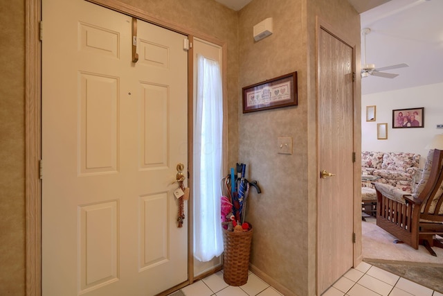 tiled foyer entrance with ceiling fan