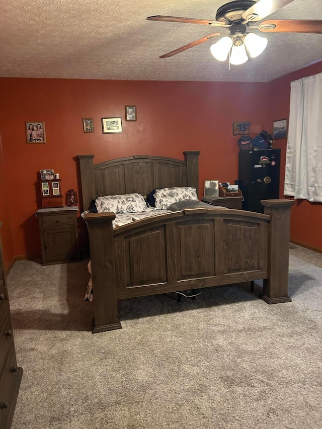 carpeted bedroom with a textured ceiling and ceiling fan