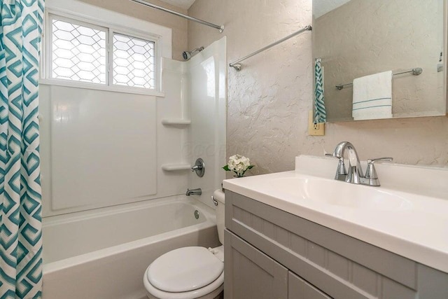 full bathroom with vanity, shower / tub combo, and toilet