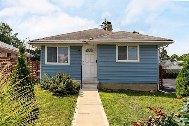 bungalow-style home featuring a front yard