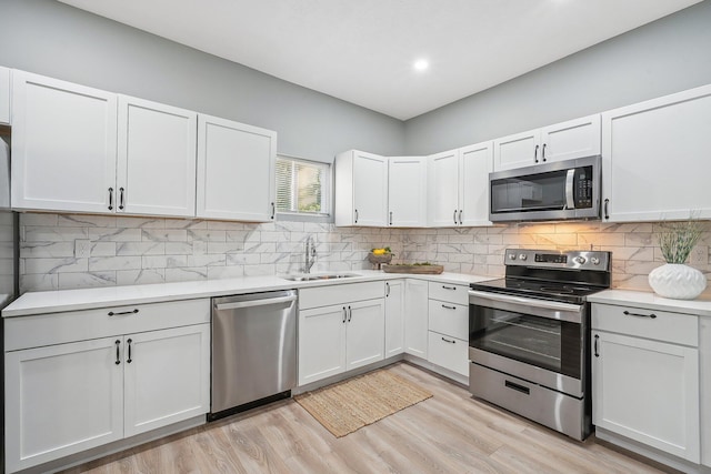 kitchen with white cabinetry, appliances with stainless steel finishes, and sink