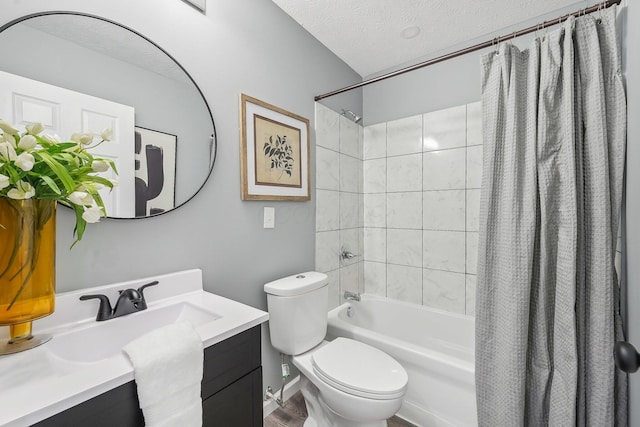 full bathroom with vanity, shower / bath combination with curtain, toilet, and a textured ceiling