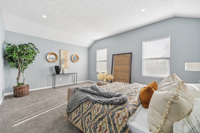 carpeted bedroom featuring lofted ceiling and a textured ceiling