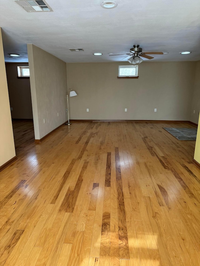 empty room featuring ceiling fan and light hardwood / wood-style floors