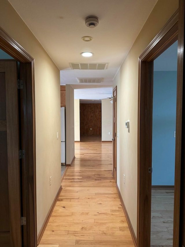 hallway with light hardwood / wood-style flooring