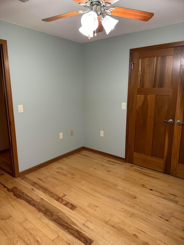 unfurnished bedroom with ceiling fan, light hardwood / wood-style floors, and a closet