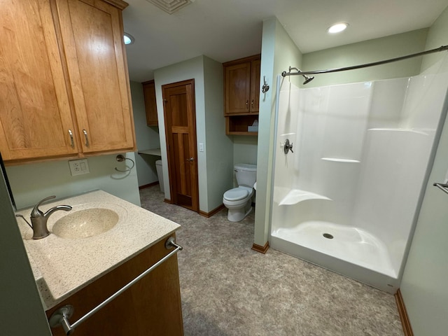 bathroom featuring vanity, toilet, and walk in shower