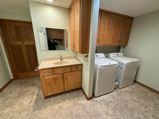 laundry area featuring cabinets, sink, and washing machine and dryer