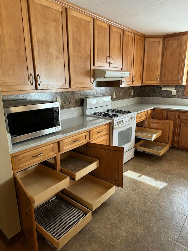 kitchen featuring decorative backsplash and gas range gas stove