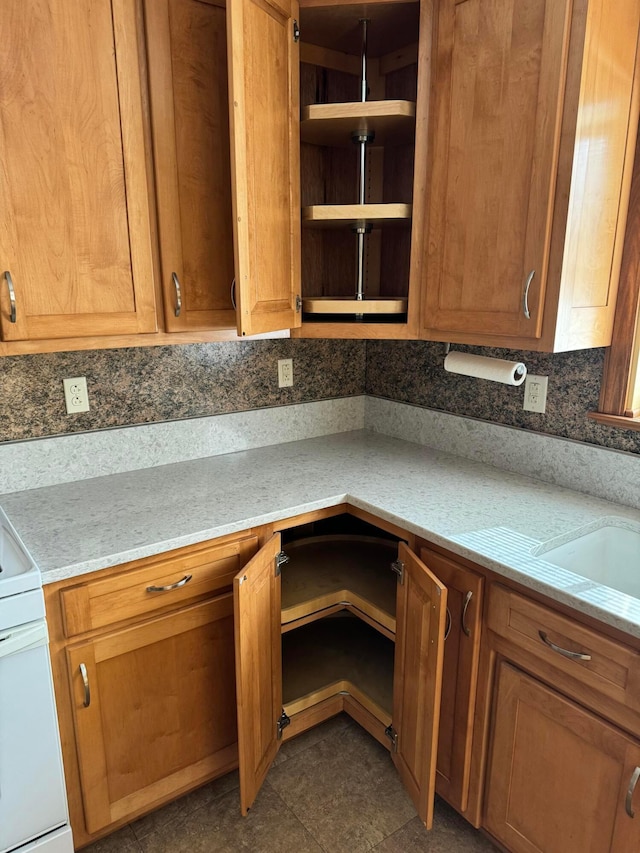 kitchen with tasteful backsplash, stove, and built in desk