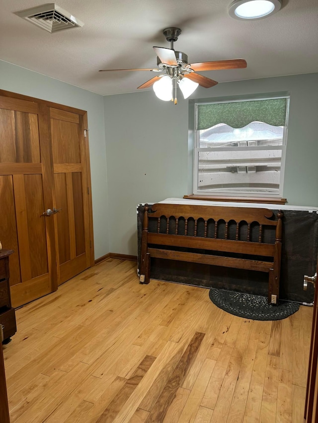 bedroom with ceiling fan and light wood-type flooring