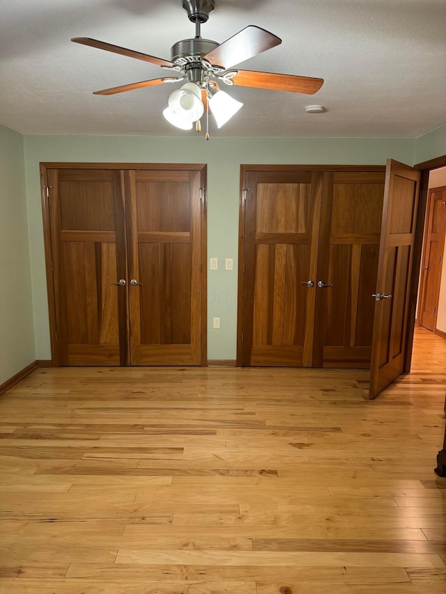 unfurnished bedroom with ceiling fan, light hardwood / wood-style floors, and a closet