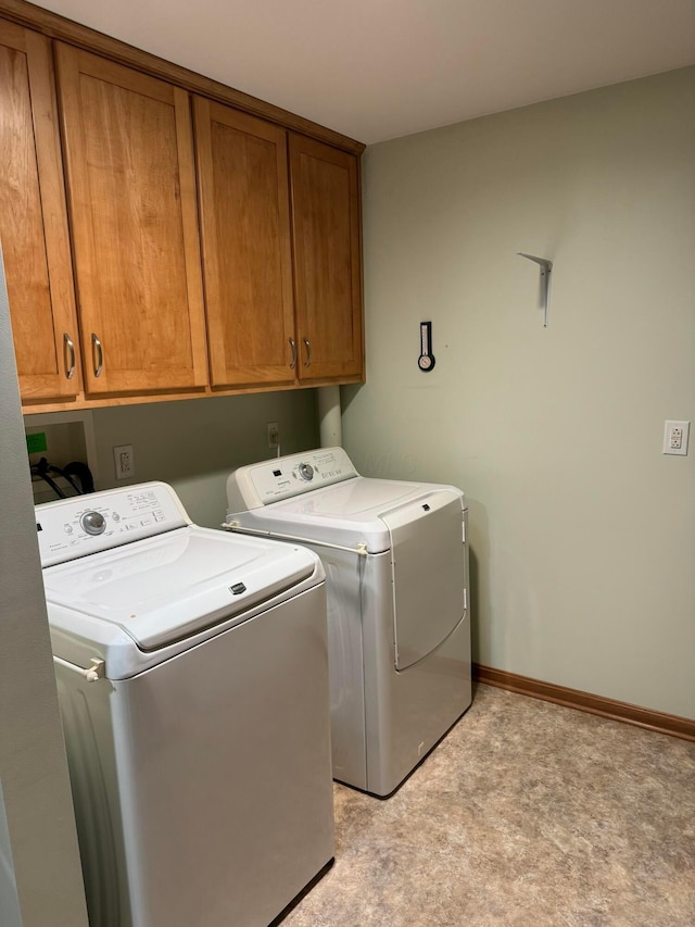 laundry room featuring cabinets and washer and dryer