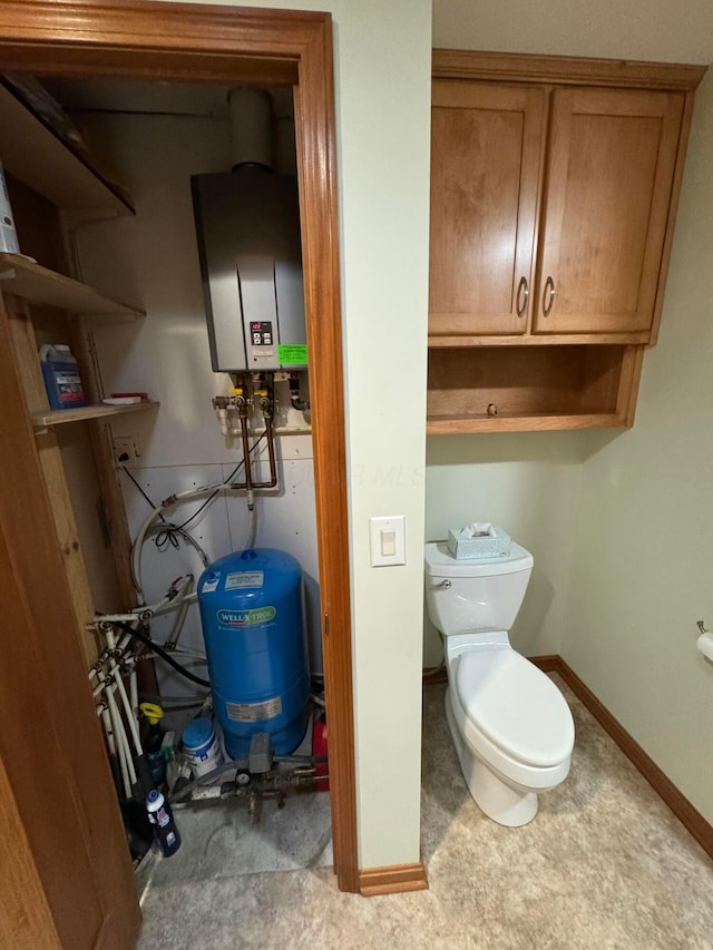 bathroom with toilet and water heater