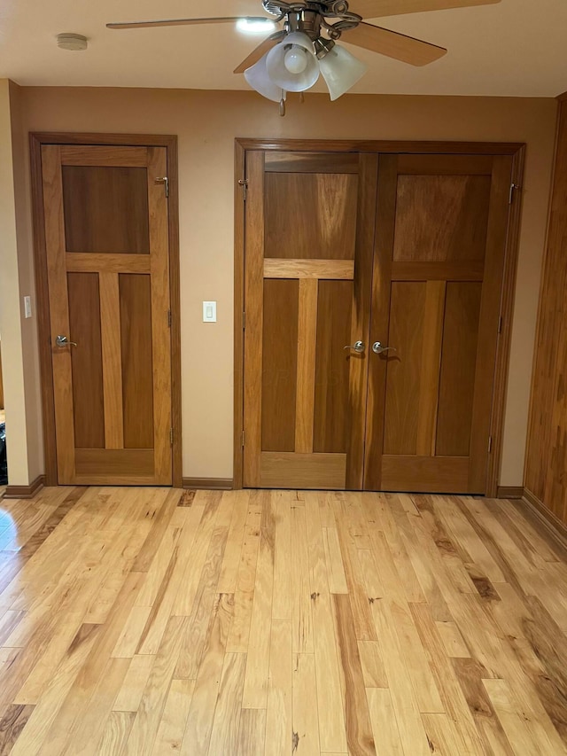 unfurnished bedroom featuring ceiling fan, light wood-type flooring, and a closet