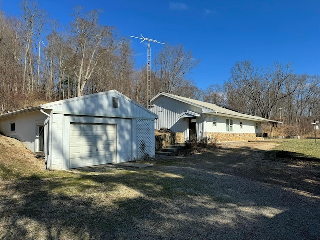 view of home's exterior featuring a garage, an outdoor structure, and a lawn