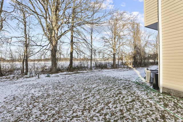 snowy yard featuring central AC unit