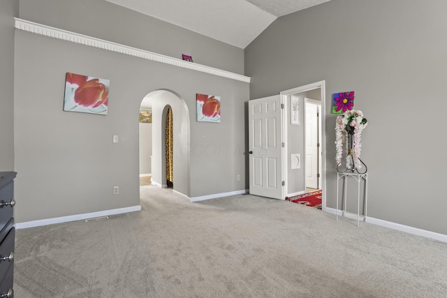 unfurnished room featuring vaulted ceiling and carpet