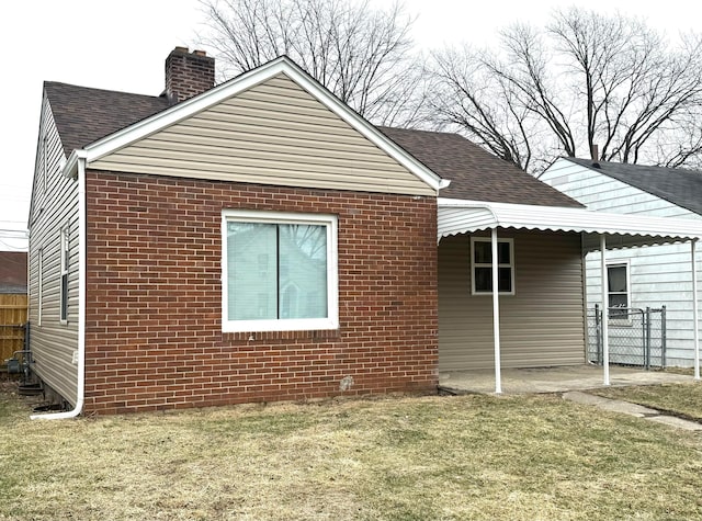 rear view of house featuring a yard