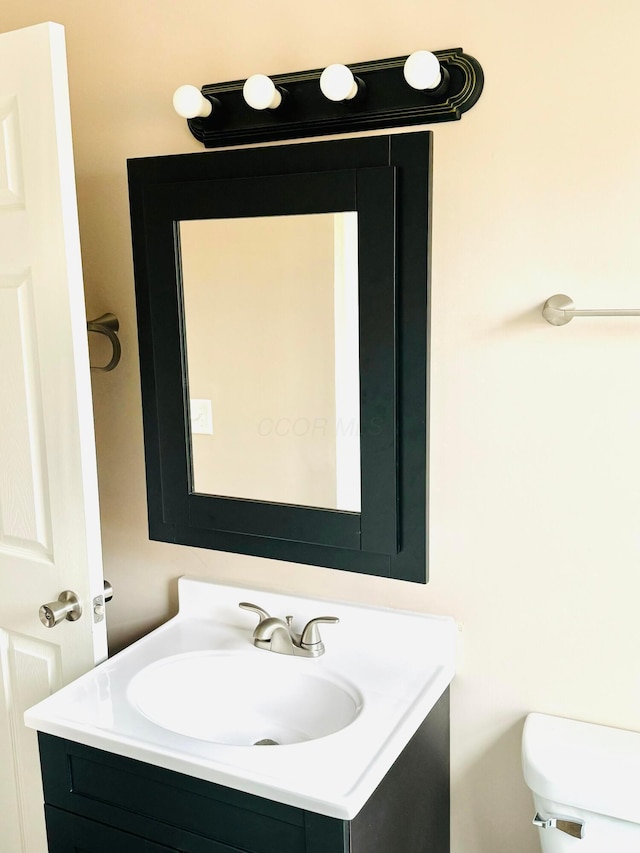 bathroom featuring vanity and toilet