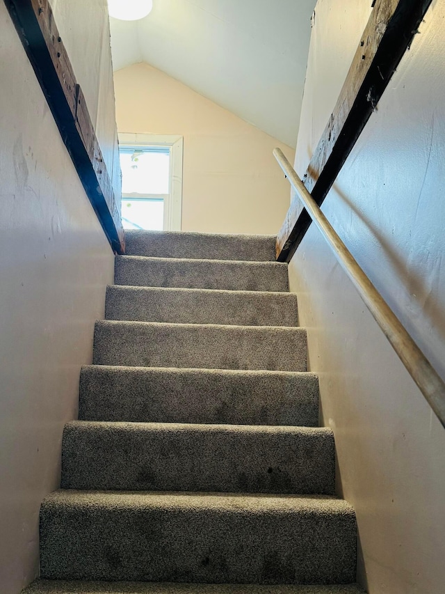 stairway featuring lofted ceiling