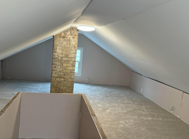 additional living space with vaulted ceiling and light colored carpet