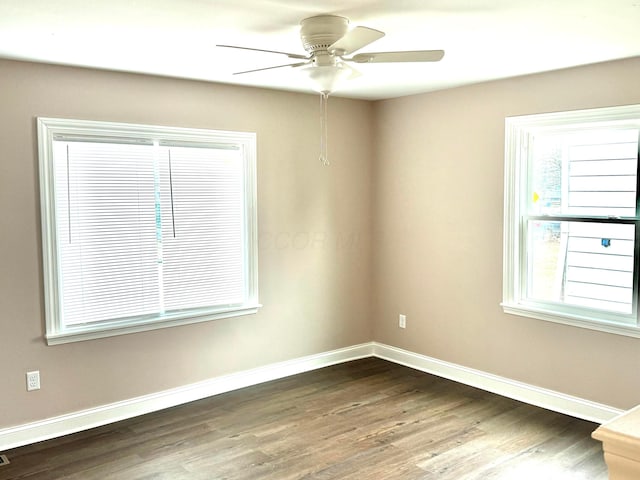 empty room featuring dark wood-type flooring and ceiling fan