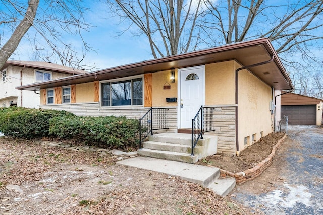 view of front of property featuring a garage and an outdoor structure