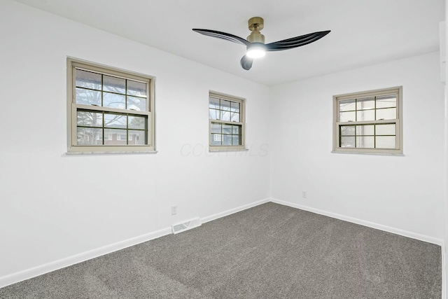 unfurnished room featuring dark carpet and ceiling fan