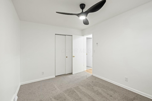 unfurnished bedroom with carpet floors, ceiling fan, and a closet