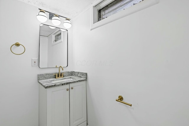 bathroom featuring vanity and a textured ceiling