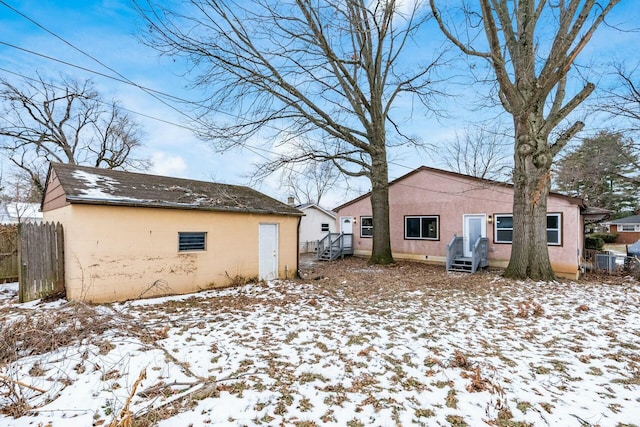 view of snow covered rear of property