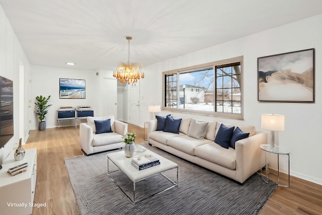 living room with a notable chandelier and wood-type flooring