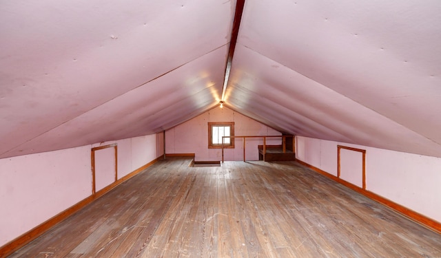 bonus room with lofted ceiling and wood-type flooring