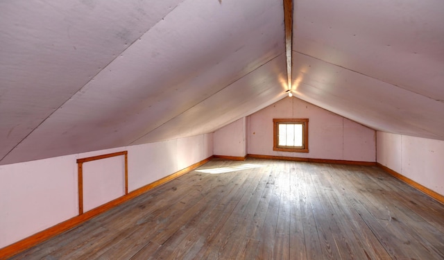 bonus room featuring light hardwood / wood-style flooring and vaulted ceiling