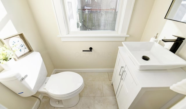 bathroom featuring tile patterned flooring, vanity, and toilet