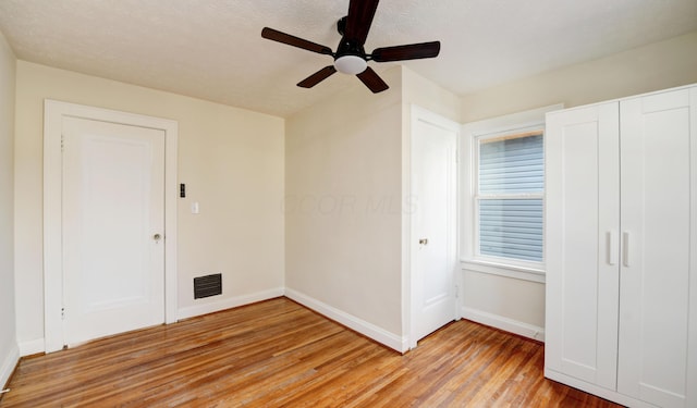 unfurnished bedroom with light hardwood / wood-style floors and ceiling fan