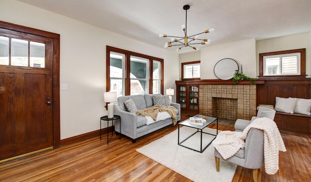 living room featuring plenty of natural light, a fireplace, and light hardwood / wood-style floors