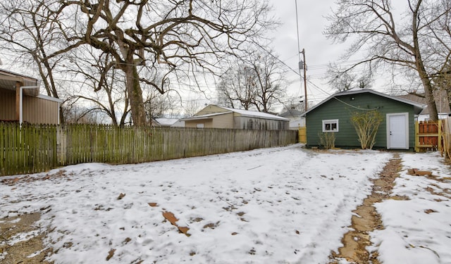 yard covered in snow featuring an outdoor structure