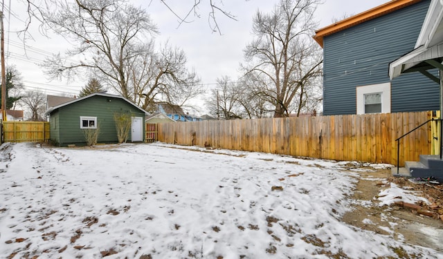 snowy yard with an outbuilding