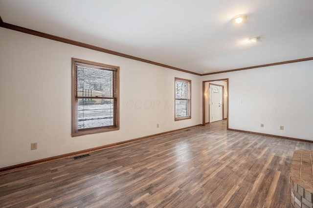 empty room featuring dark hardwood / wood-style flooring and crown molding