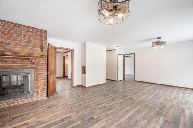 unfurnished living room featuring wood-type flooring and a fireplace