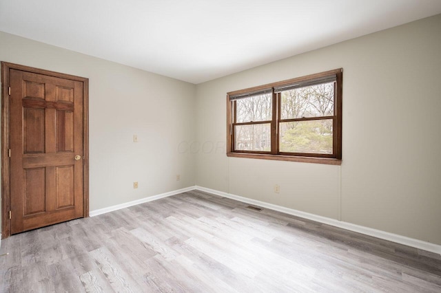 unfurnished room with light hardwood / wood-style flooring