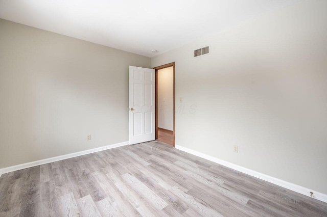 spare room with light hardwood / wood-style floors