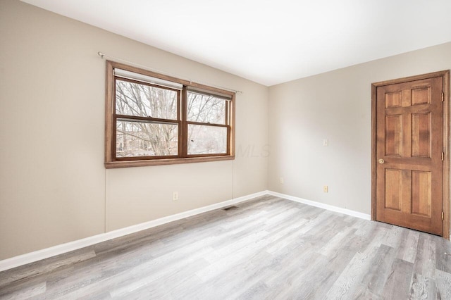 spare room featuring light wood-type flooring