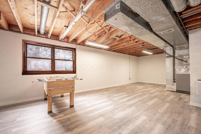 basement featuring hardwood / wood-style floors