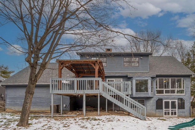 snow covered house featuring a deck