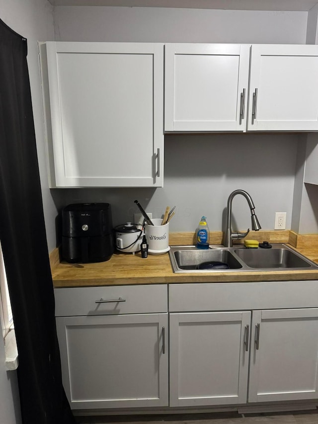 kitchen featuring sink and white cabinets